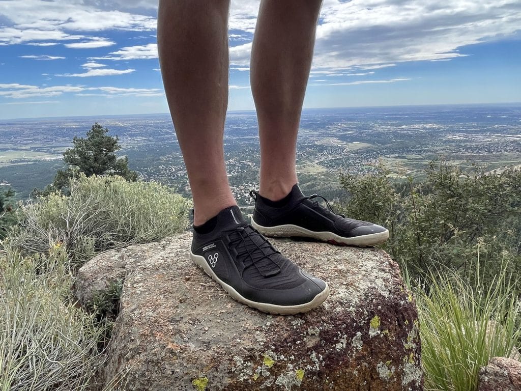 Image of runner wearing Vivobarefoot Primus All Weather shoe for outdoor adventure.